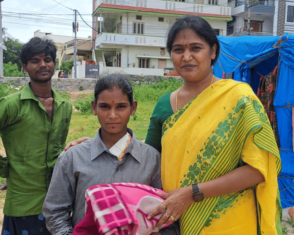 Volunteer giving blanket to woman in need