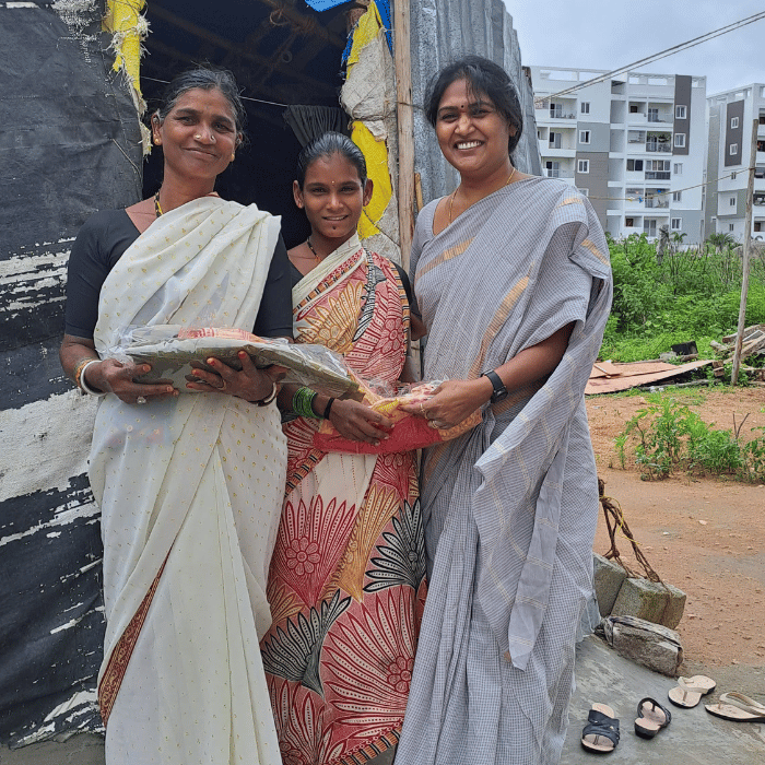 Charity volunteers with women receiving relief supplies
