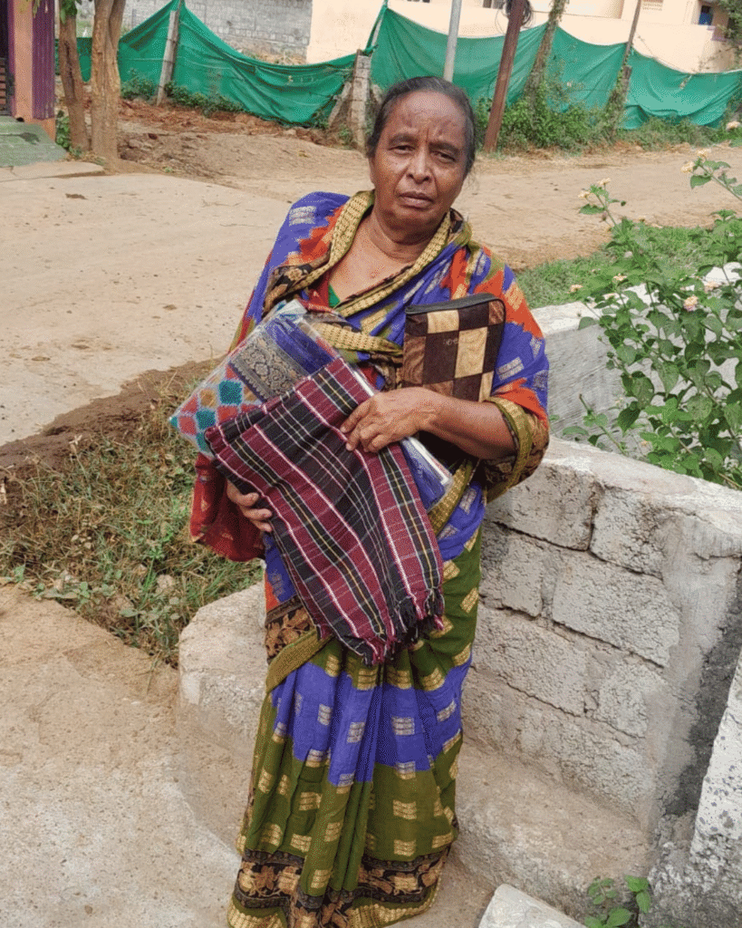 Woman receives clothing relief kit from charity